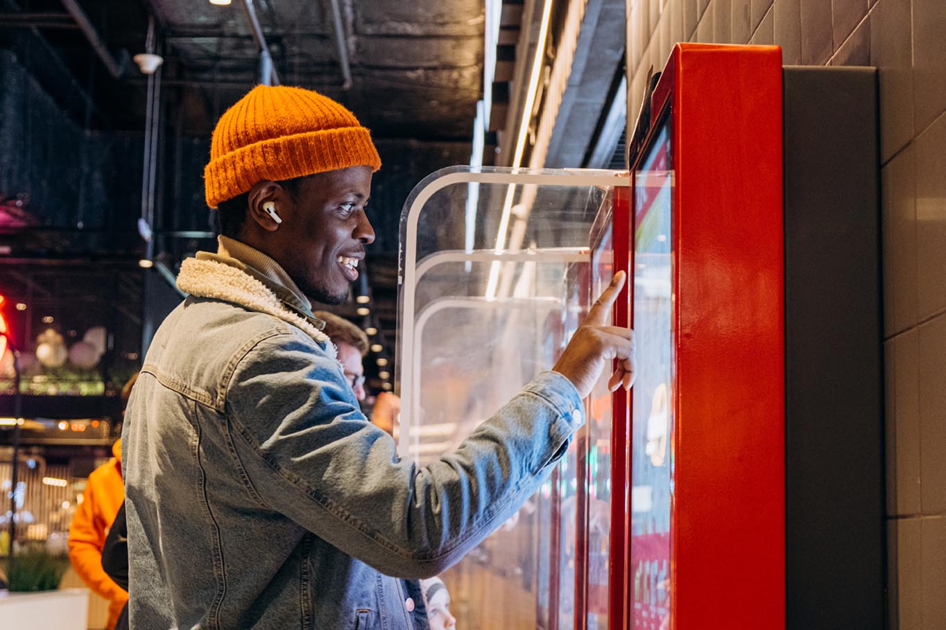 Guy orders food with self service kiosk